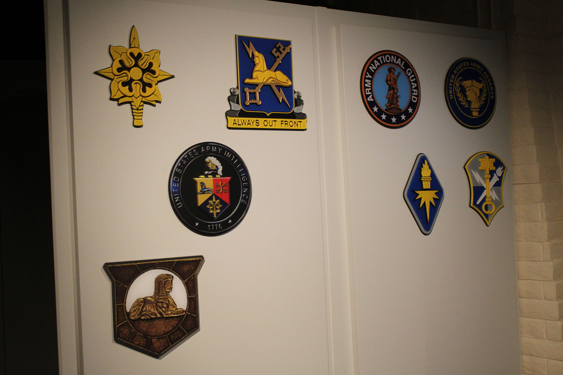 A wall display of several Army emblems.